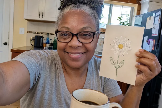Denise R. with her finished paper-embroidery